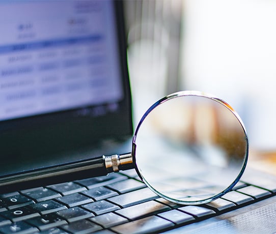 Magnifying glass on laptop