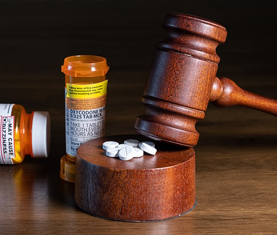 Oxycodone pills arranged on judge's gavel