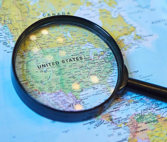 Magnifying glass on map of United States of America