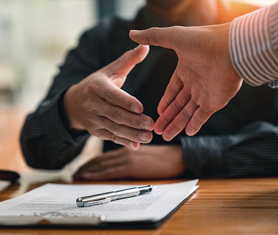 Two people about to shake hands 