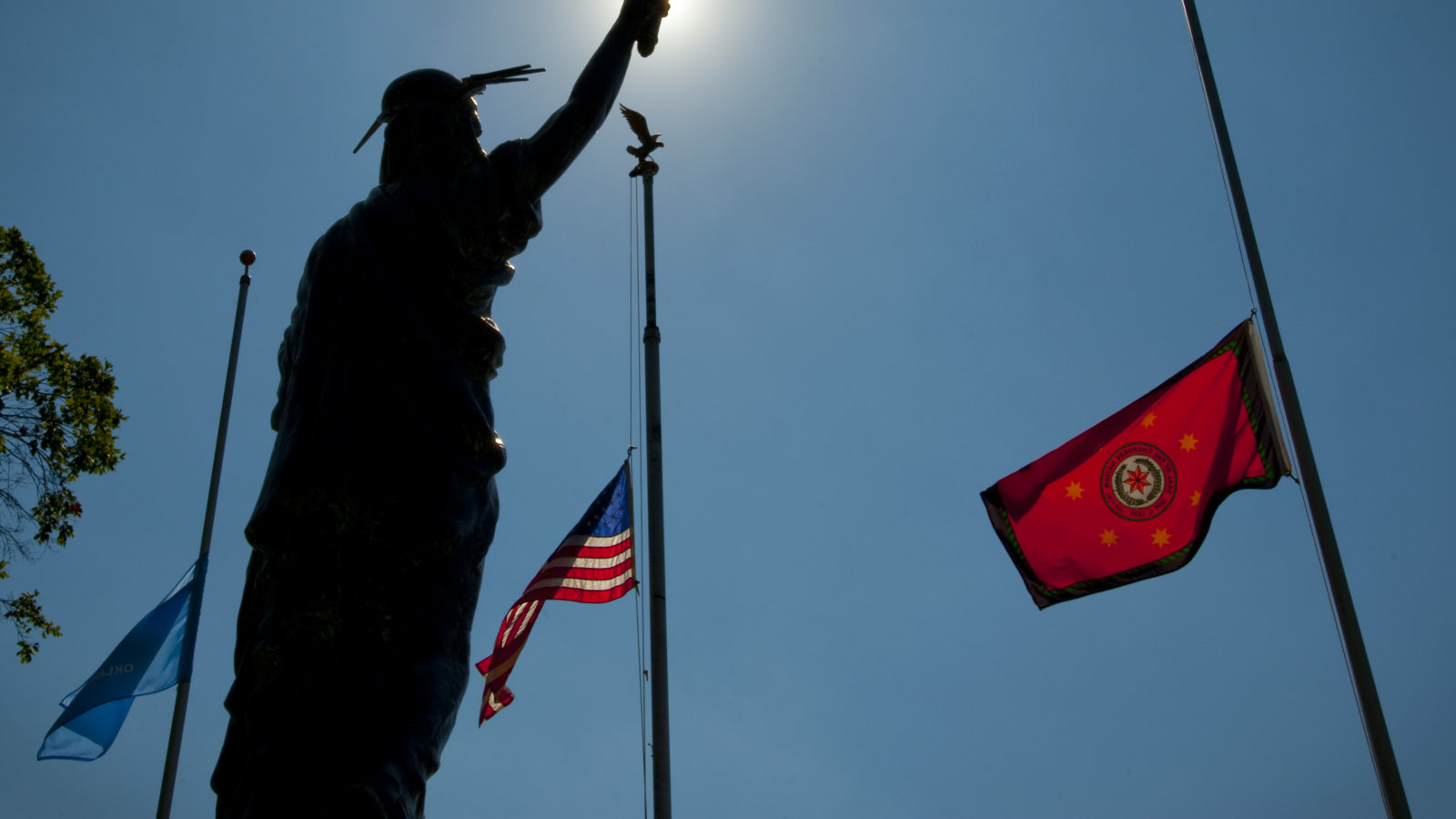 statue and flags on flagpole