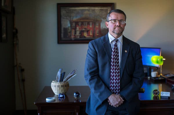 man in suit standing at desk